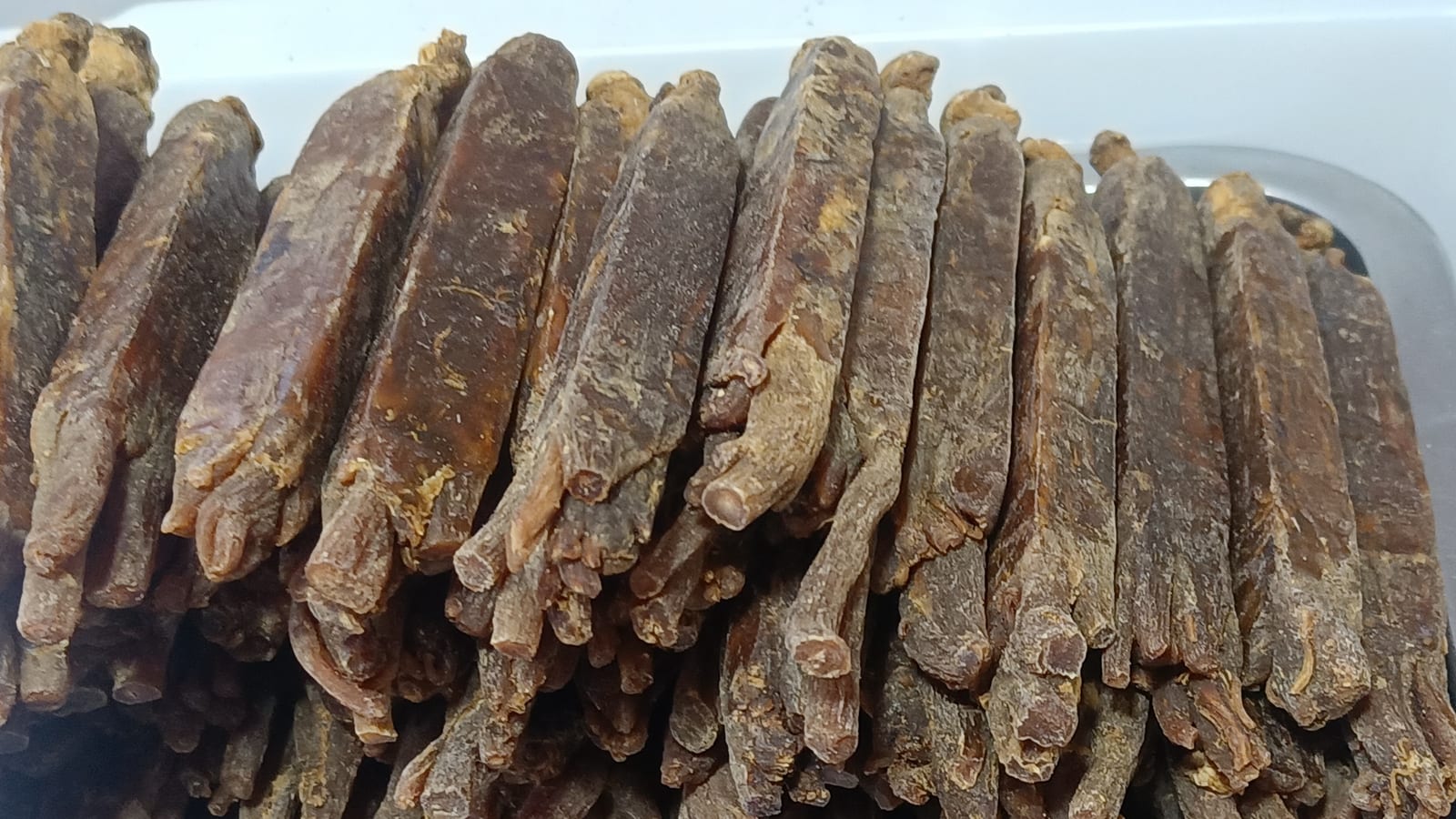 Dried Panax ginseng roots stacked on a tray